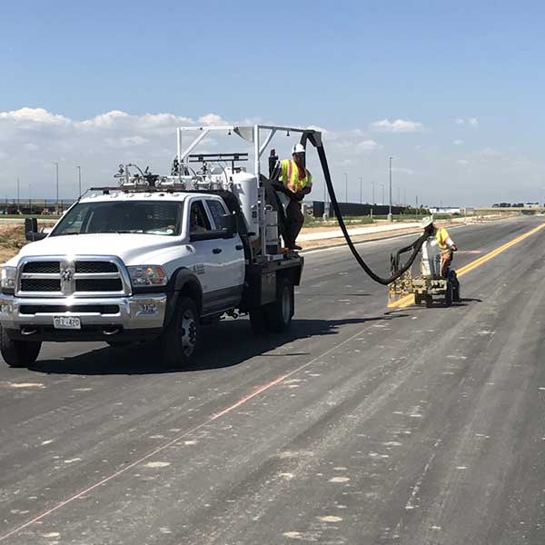 Men doing striping work on a road